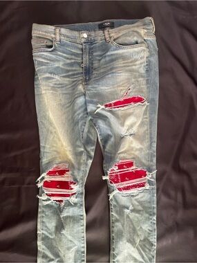 AMIRI Light Blue Skinny Jeans with Red Patch Accents